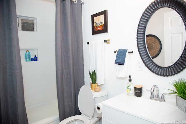 full bathroom with vanity, toilet, and shower / tub combo with curtain