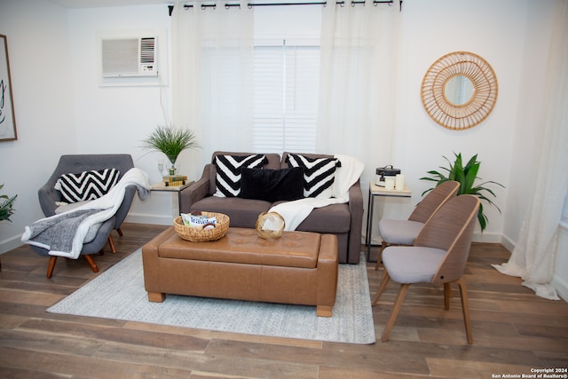 living area featuring an AC wall unit and hardwood / wood-style flooring