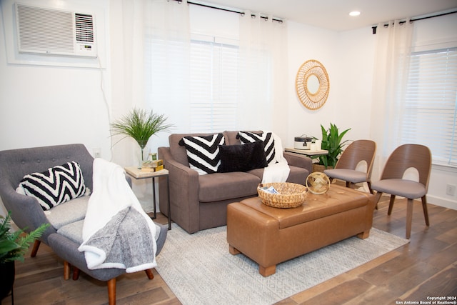 living room with plenty of natural light, hardwood / wood-style floors, and a wall mounted AC