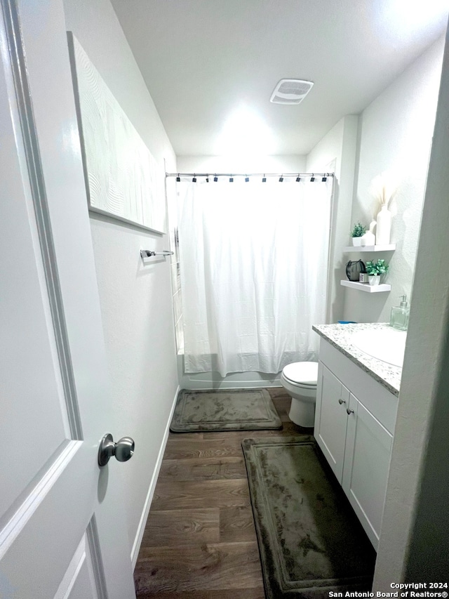 bathroom featuring vanity, toilet, wood-type flooring, and a shower with shower curtain