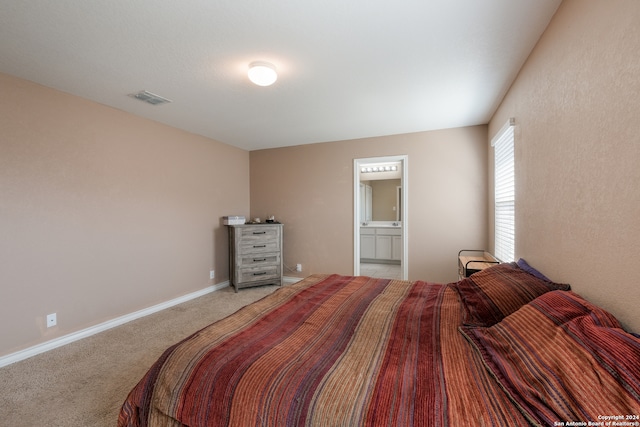 carpeted bedroom with a walk in closet