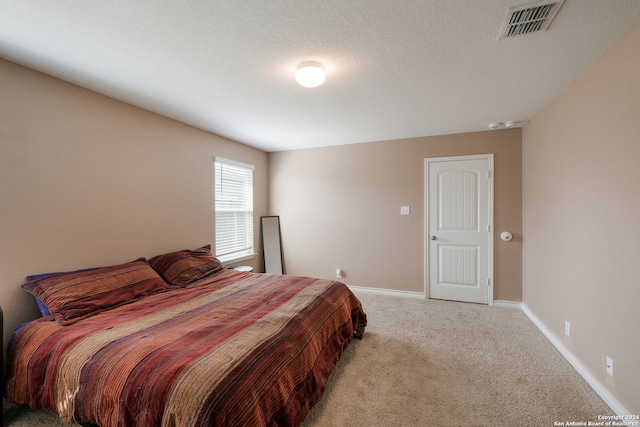 carpeted bedroom with a textured ceiling