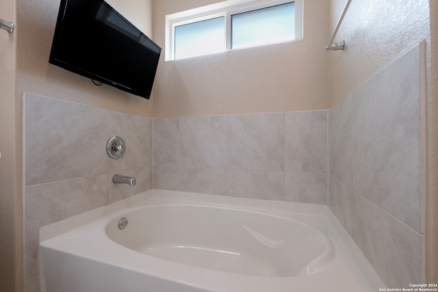 bathroom featuring a washtub