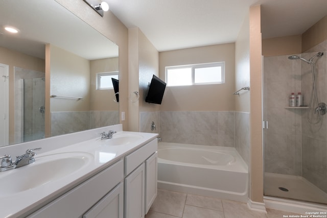 bathroom with tile patterned floors, separate shower and tub, and vanity