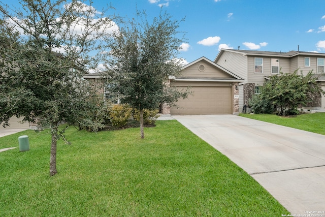 view of front facade with a front lawn and a garage