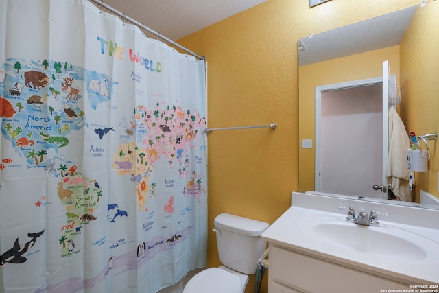 bathroom featuring a textured ceiling, a shower with shower curtain, vanity, and toilet