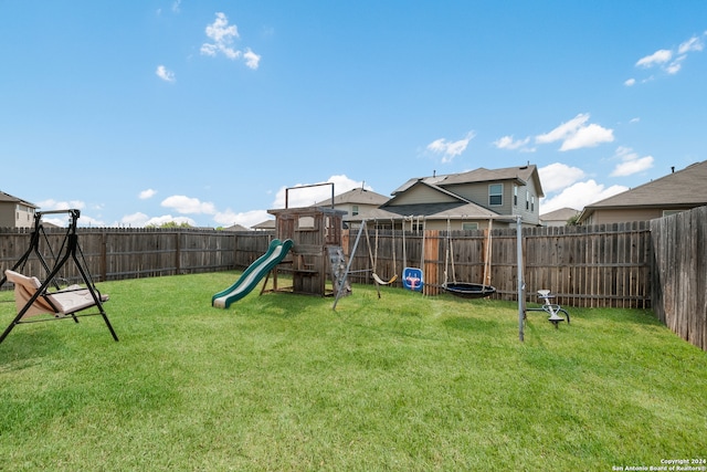 view of jungle gym featuring a lawn