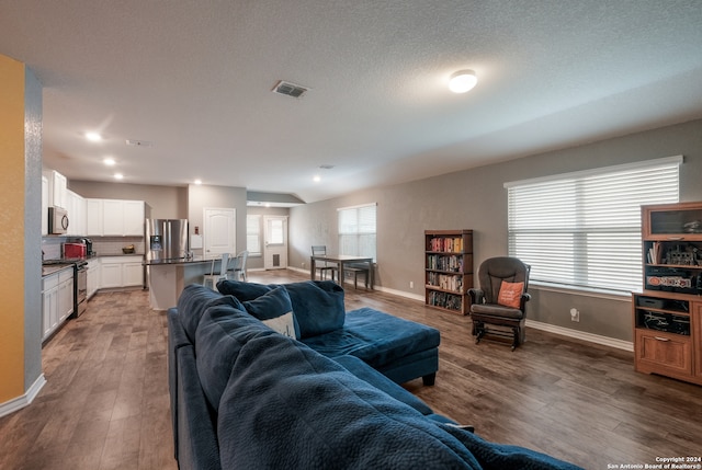 living room featuring a textured ceiling and hardwood / wood-style floors