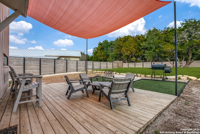 wooden terrace with a yard and a grill