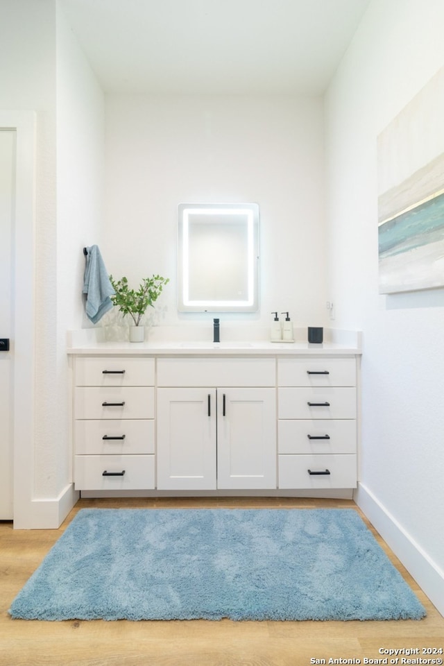 bathroom with vanity and wood-type flooring