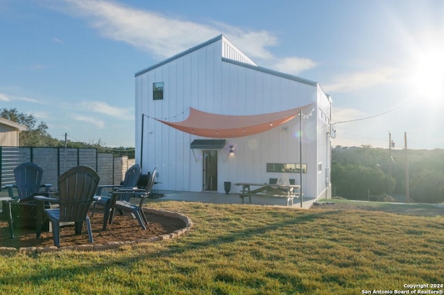 rear view of house featuring a yard and a patio area