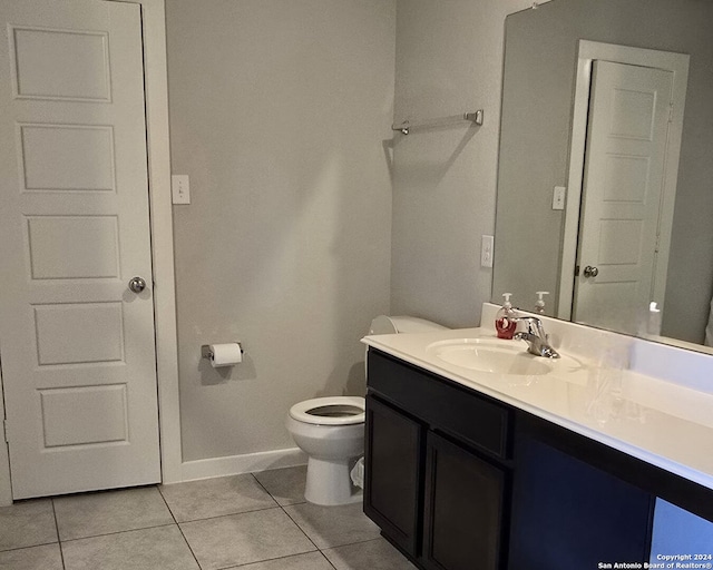 bathroom with tile patterned floors, vanity, and toilet