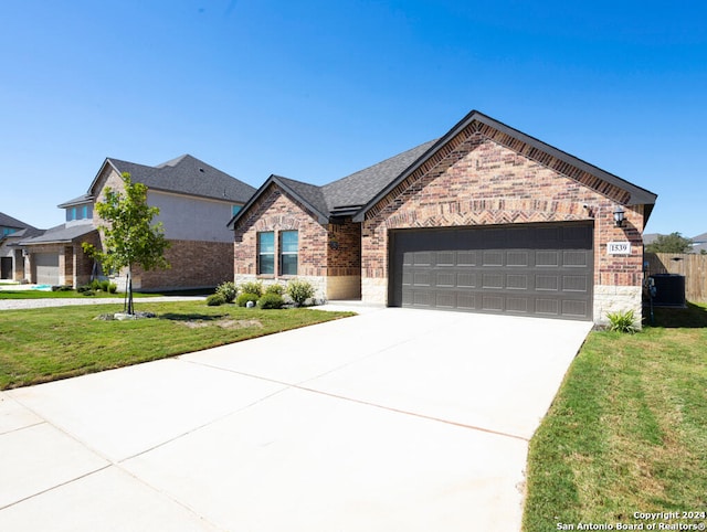 view of front of property with a front yard and a garage