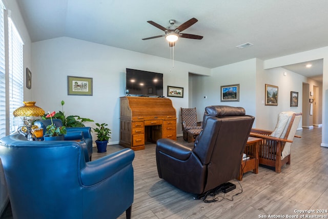 living room featuring lofted ceiling, ceiling fan, and light hardwood / wood-style flooring