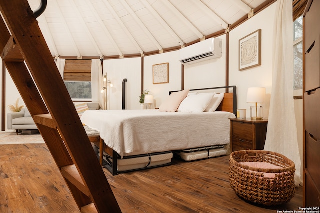 bedroom featuring lofted ceiling with beams, hardwood / wood-style floors, multiple windows, and a wall mounted AC