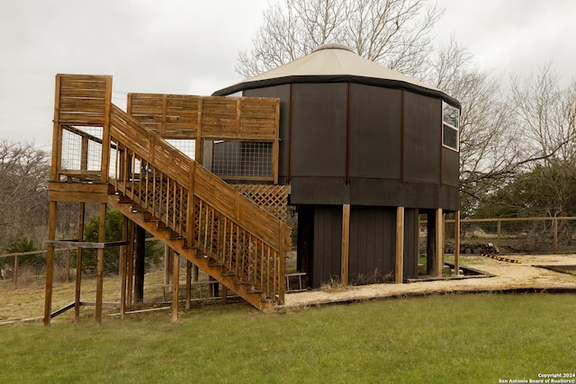 rear view of house featuring a yard