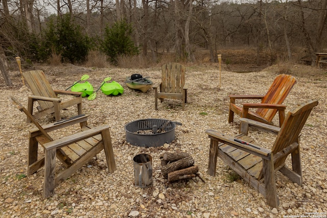 view of community featuring an outdoor fire pit