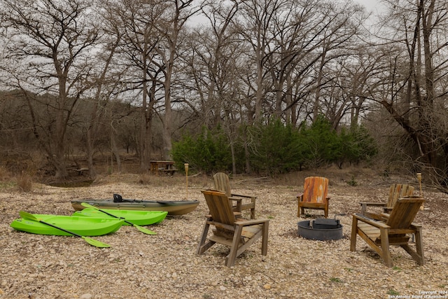 view of yard featuring an outdoor fire pit