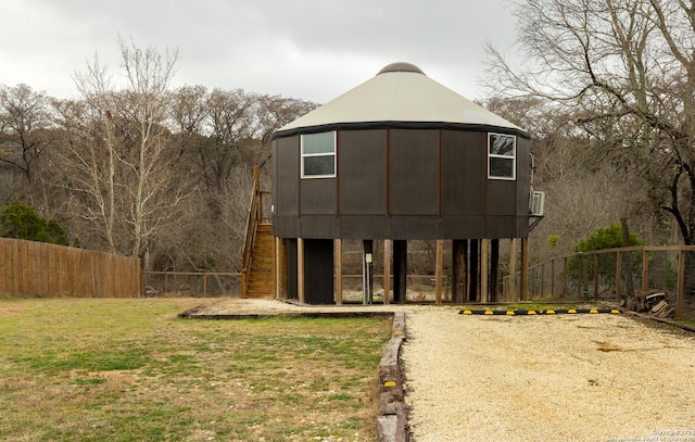 rear view of house featuring a lawn