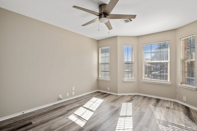 empty room featuring light hardwood / wood-style flooring and ceiling fan