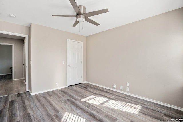 unfurnished bedroom featuring hardwood / wood-style floors and ceiling fan