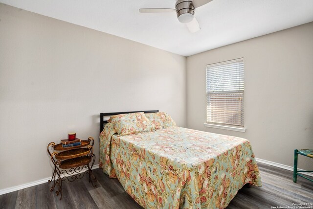 bedroom featuring ceiling fan and dark hardwood / wood-style floors