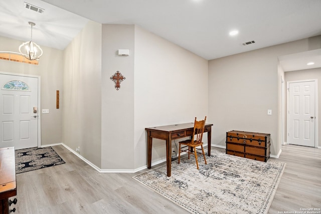 foyer entrance featuring an inviting chandelier and light wood-type flooring