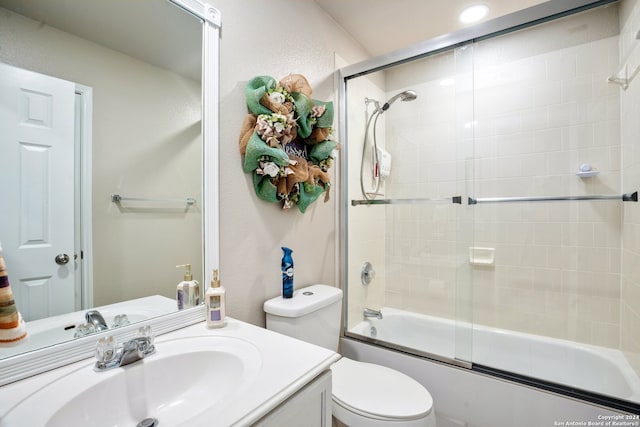 full bathroom with vanity, enclosed tub / shower combo, and toilet