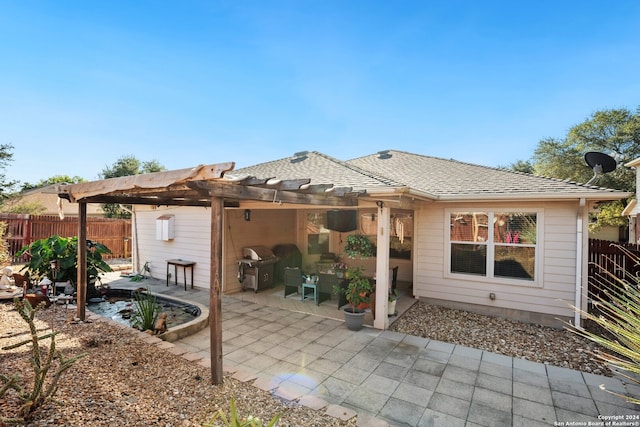 rear view of property with a patio area and a pergola