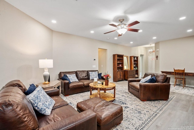 living room with ceiling fan, recessed lighting, and light wood-style flooring