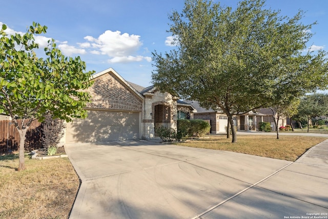 5018 Italica Rd, San Antonio, TX 78253 - view of front facade featuring an attached garage, brick siding, driveway, and stone siding
