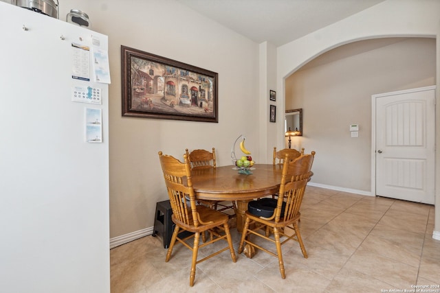 dining space featuring light tile patterned flooring