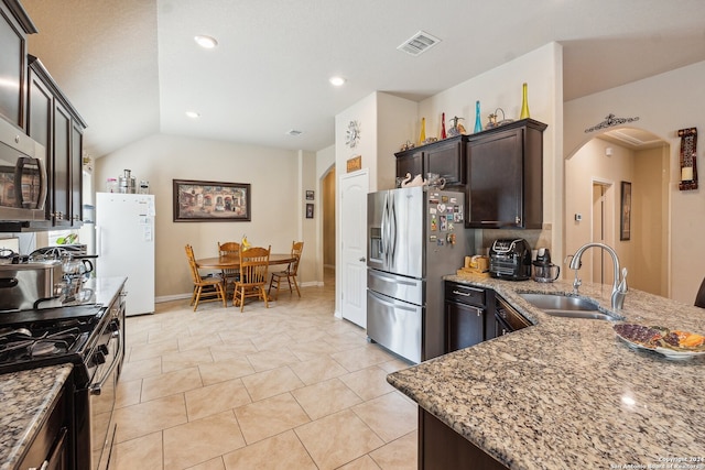 5018 Italica Rd, San Antonio, TX 78253 - kitchen featuring visible vents, light stone countertops, arched walkways, a sink, and appliances with stainless steel finishes