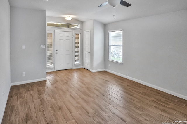 foyer entrance featuring light wood-type flooring and ceiling fan