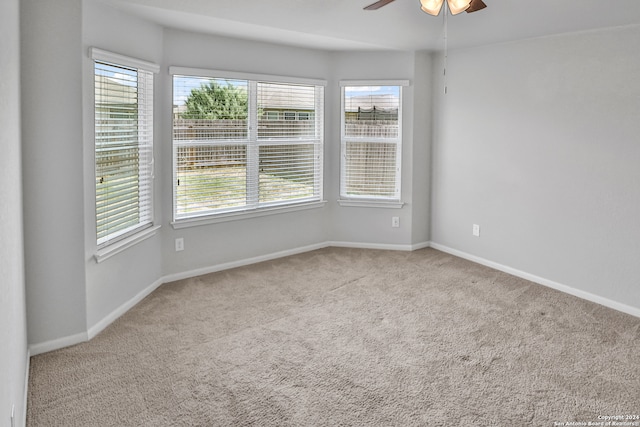 unfurnished room with ceiling fan and light colored carpet