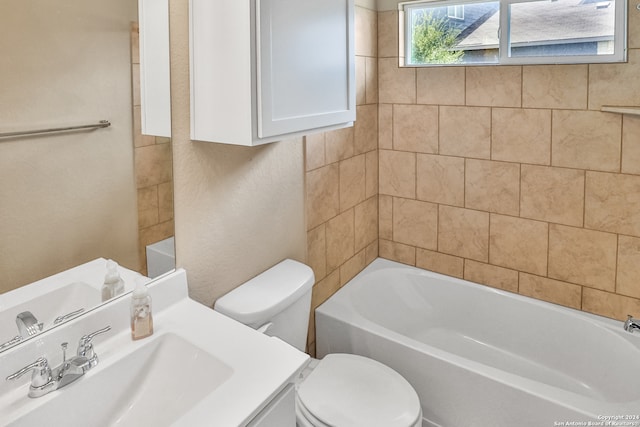 bathroom featuring a bathing tub, vanity, and toilet