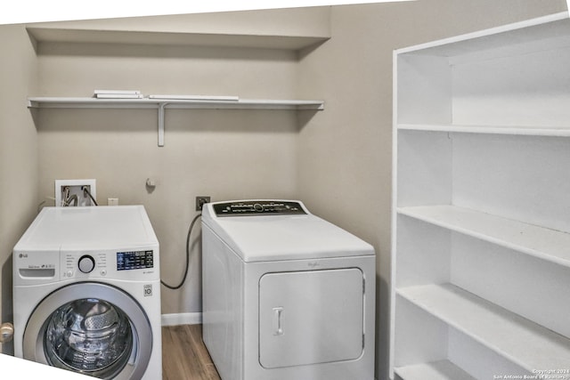 laundry room featuring hardwood / wood-style flooring and washing machine and dryer