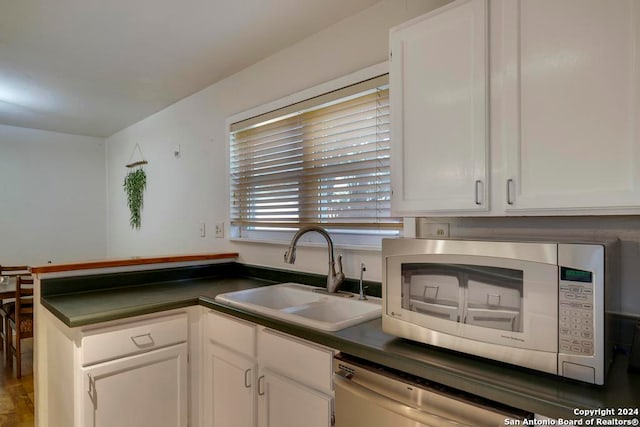 kitchen featuring white cabinets and sink