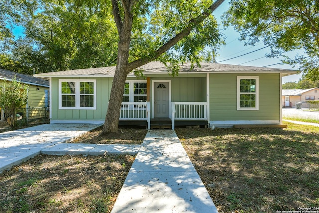 2293 W Mill St, New Braunfels, TX 78130 - bungalow featuring covered porch, board and batten siding, and roof with shingles