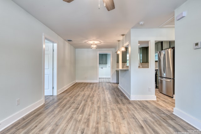 unfurnished living room with ceiling fan and light hardwood / wood-style floors