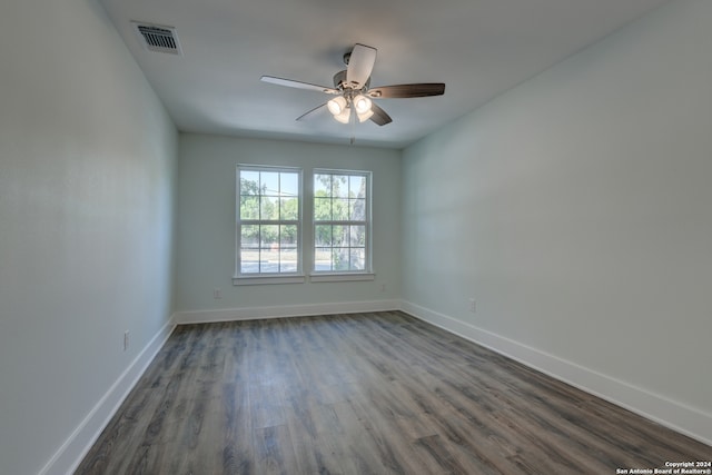 unfurnished room with ceiling fan and dark hardwood / wood-style floors