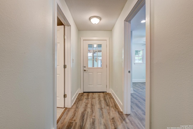 2293 W Mill St, New Braunfels, TX 78130 - doorway to outside featuring wood finished floors, baseboards, and a textured wall