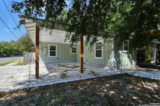 2293 W Mill St, New Braunfels, TX 78130 - rear view of house with board and batten siding and a patio area