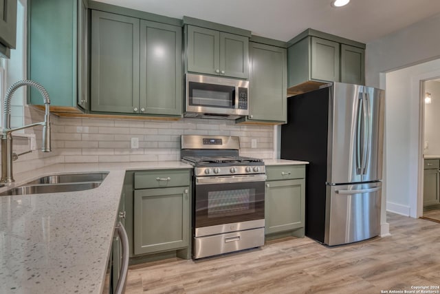 2293 W Mill St, New Braunfels, TX 78130 - kitchen with green cabinetry, stainless steel appliances, and recessed lighting