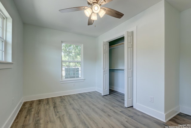 2293 W Mill St, New Braunfels, TX 78130 - unfurnished bedroom with wood finished floors, a closet, and baseboards