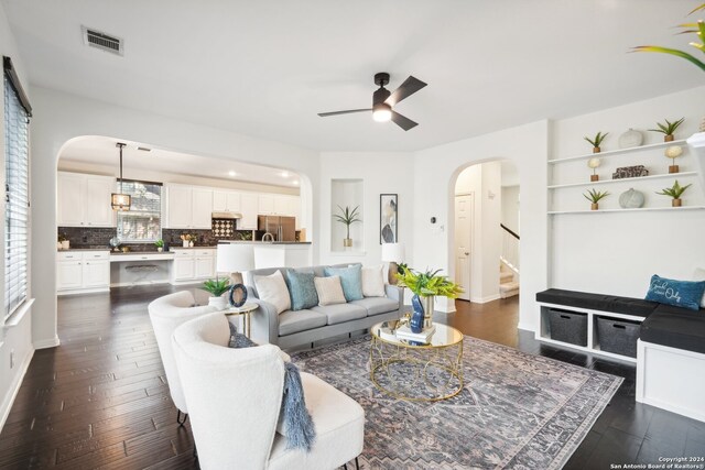 living room with ceiling fan and dark hardwood / wood-style floors