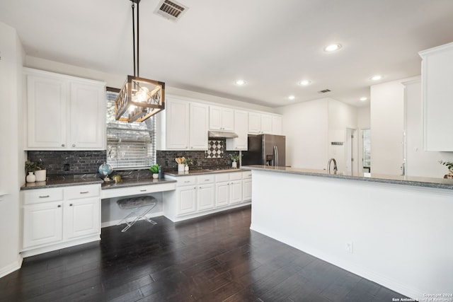 kitchen featuring dark stone counters, stainless steel fridge with ice dispenser, white cabinetry, and dark hardwood / wood-style floors