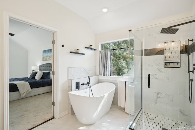 bathroom featuring vaulted ceiling and independent shower and bath