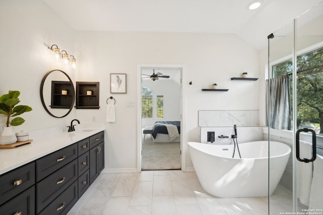 bathroom with lofted ceiling, plenty of natural light, a bath, and vanity