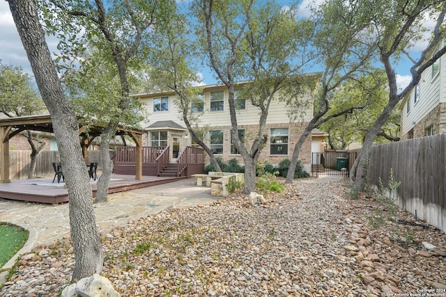 rear view of property featuring a deck and a patio